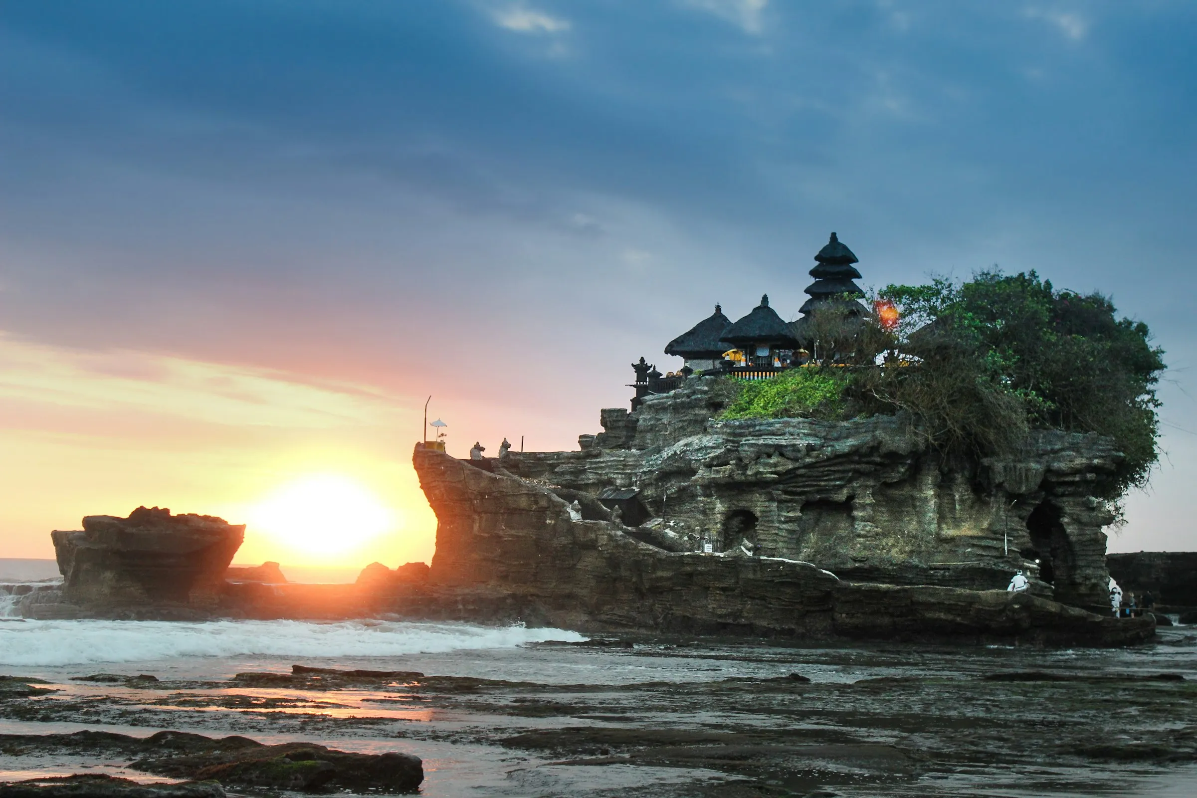 Tanah Lot temple silhouetted on a sea rock at sunset, Bali